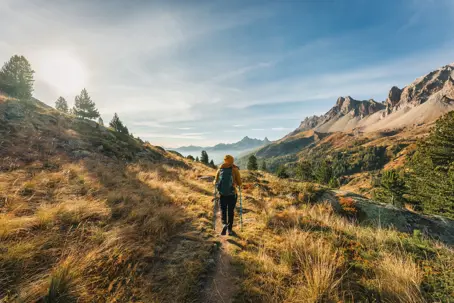 Hiker walking along a trail in the mountains