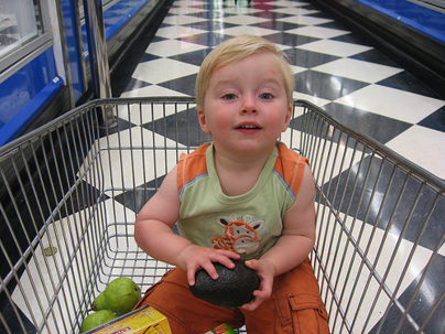 a kid in a shopping cart