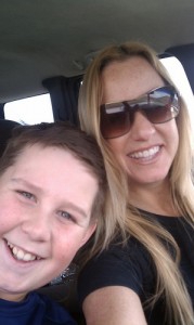 a mom and son taking a selfie in a car.